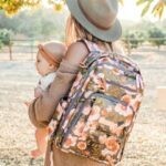 A mom carrying the Best jujube diaper bag