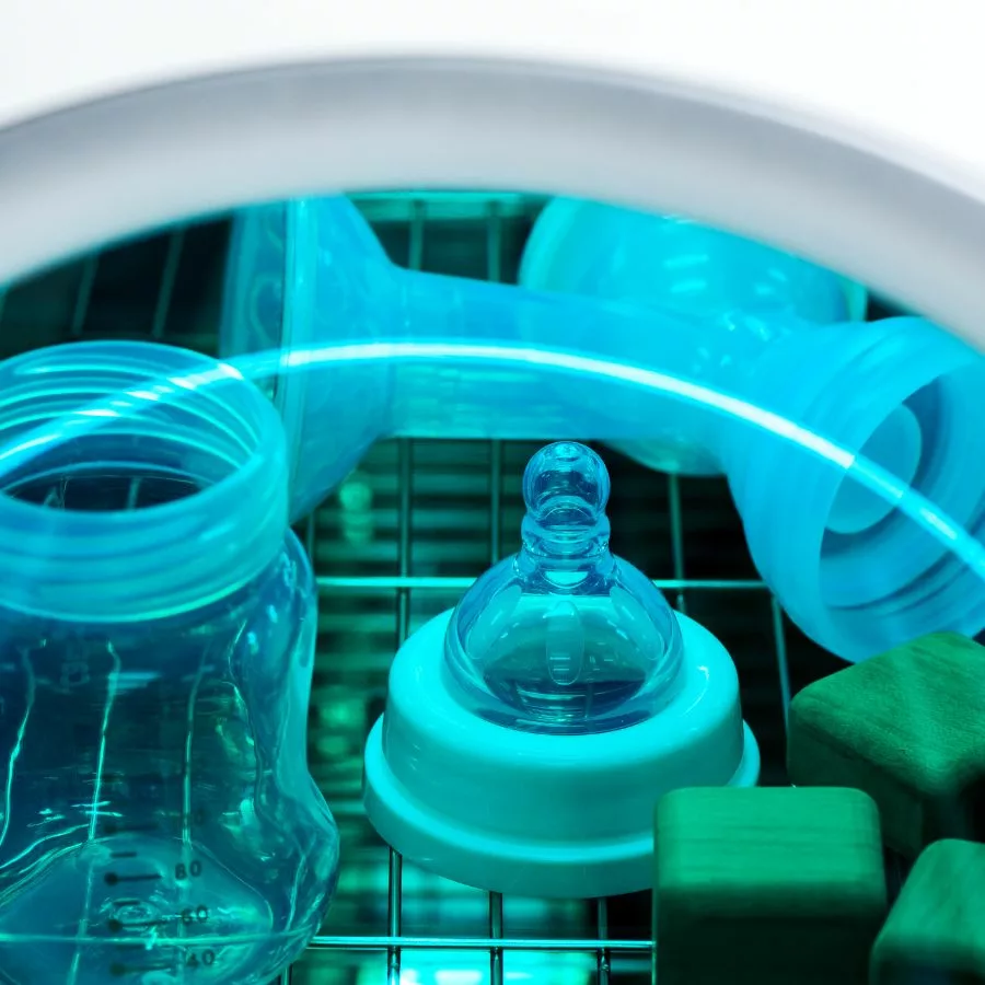 baby bottles and toys in uv sterilizer with blue light