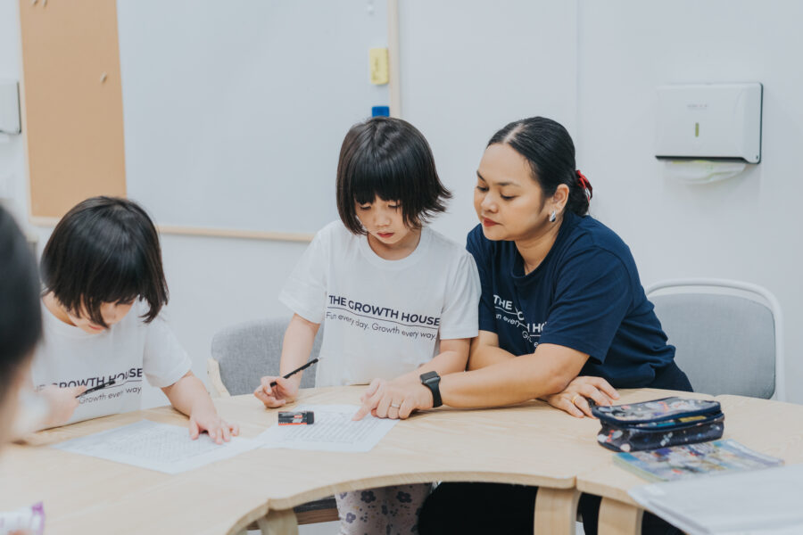 Teacher guiding student on how to complete the curated supplementary worksheets.