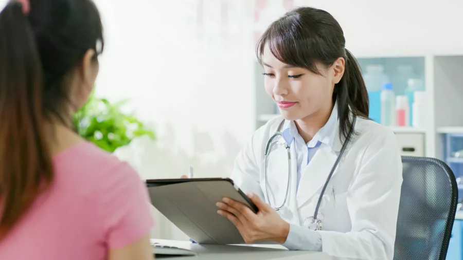 Seorang ibu sedang konsultasi dengan dokter kandungan, karena test pack negatif tapi belum haid