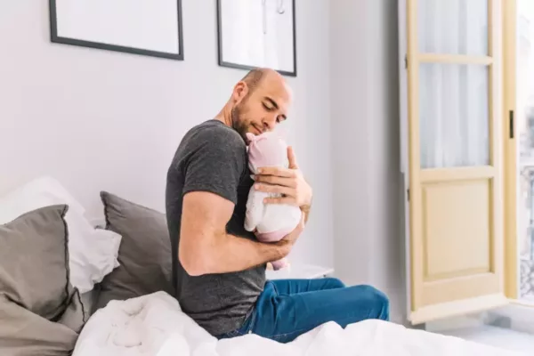 father-holding-baby-bedroom